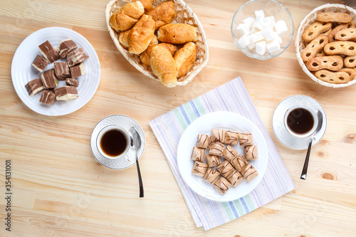 Wallpaper Mural Cup of coffee on a napkin a wooden table and sweets with sugar. Torontodigital.ca