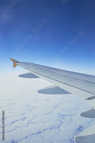 Cloudscape from window airplane, landscape of wing plane on a cloudy sky