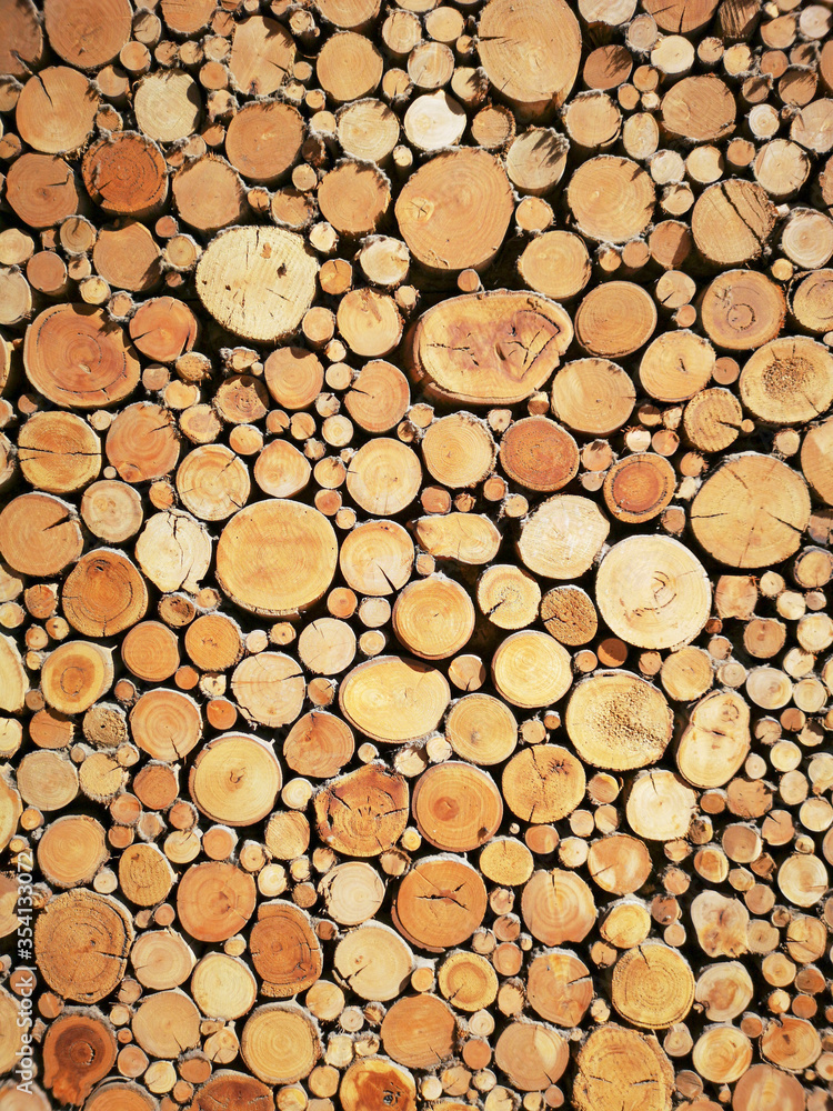 Sawn timber logs stacked for a wood burning stove. Close up in full frame and a vertical format. Sawn timber logs stacked for a wood burning stove. Close up in full frame and a vertical format.