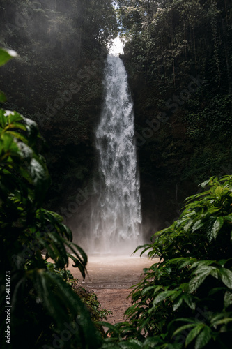 Nungnung Waterfall splashing in Bali Jungle  Indonesia