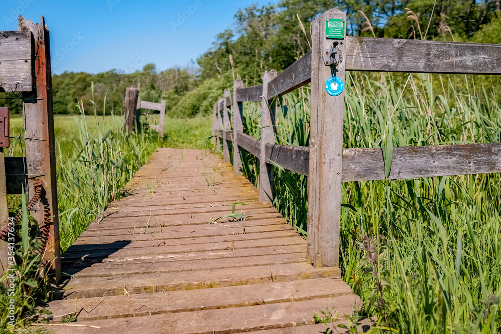 Wooden bridge over the Honing and Dilham canal in the Norfolk countryside Wooden bridge over the Honing and Dilham canal in the Norfolk countryside