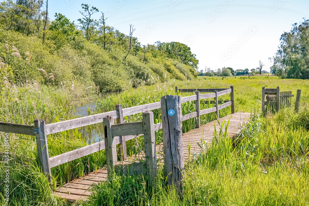 Wooden bridge over the Honing and Dilham canal in the Norfolk countryside Wooden bridge over the Honing and Dilham canal in the Norfolk countryside