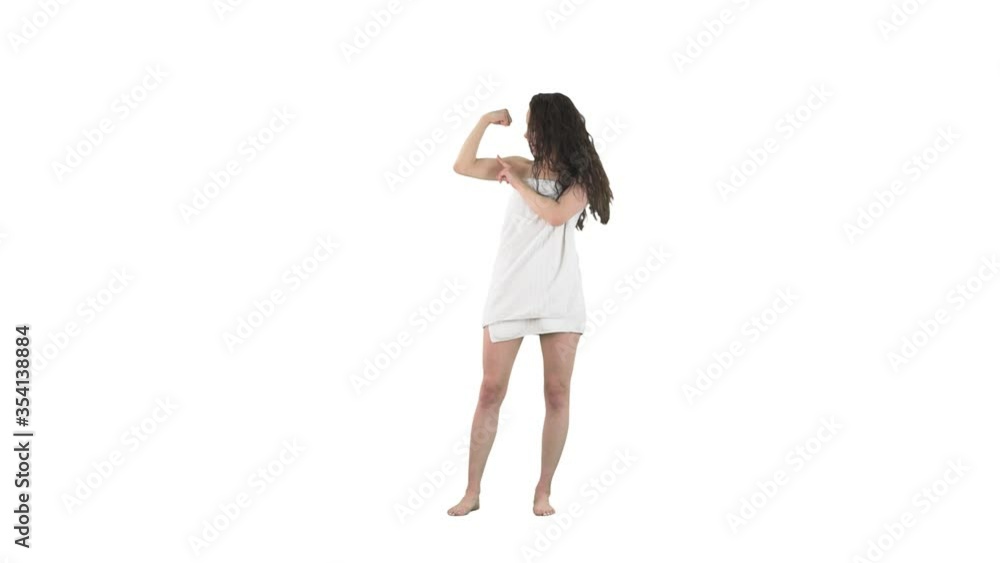 Girl power concept. Slim young woman in towel flexing bicep muscles showing off isolated on solid white background. Girl power concept. Slim young woman in towel flexing bicep muscles showing off isolated on solid white background.