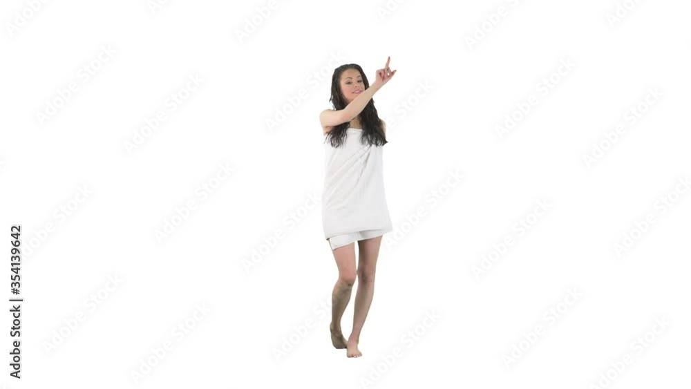 Young attractive woman wet in towel after bath using interactive invisible touch screen isolated on solid white background. Young attractive woman wet in towel after bath using interactive invisible touch screen isolated on solid white background.