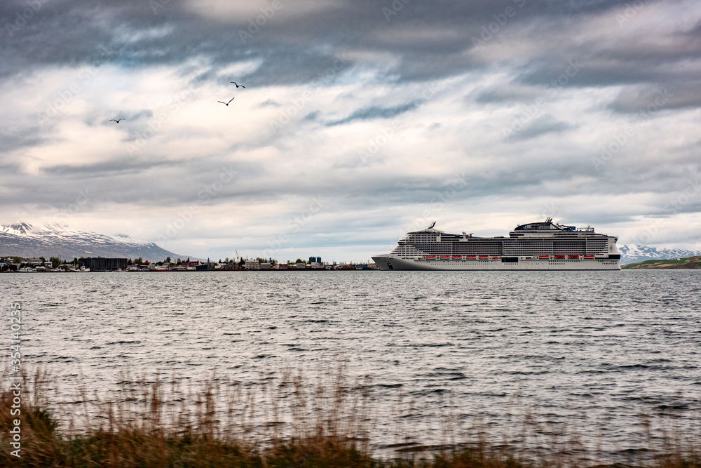 Panoramic view of the big cruise ship is docked in the city of Akureyri in Northern Iceland