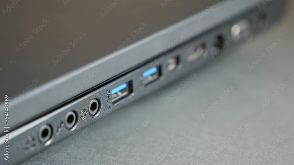 Close up shot of USB, HDMI and other I/O port of modern laptop. Side view. Close up shot of USB, HDMI and other I/O port of modern laptop. Side view.
