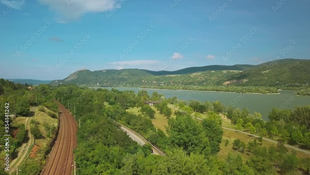 Aerial drone view in the turn of the river Danube in Hungary over Nagymaros. Railway lines Aerial drone view in the turn of the river Danube in Hungary over Nagymaros. Railway lines