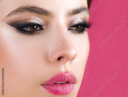 Картината върху платно Closeup of beautiful young female model with soft smooth skin and professional facial makeup