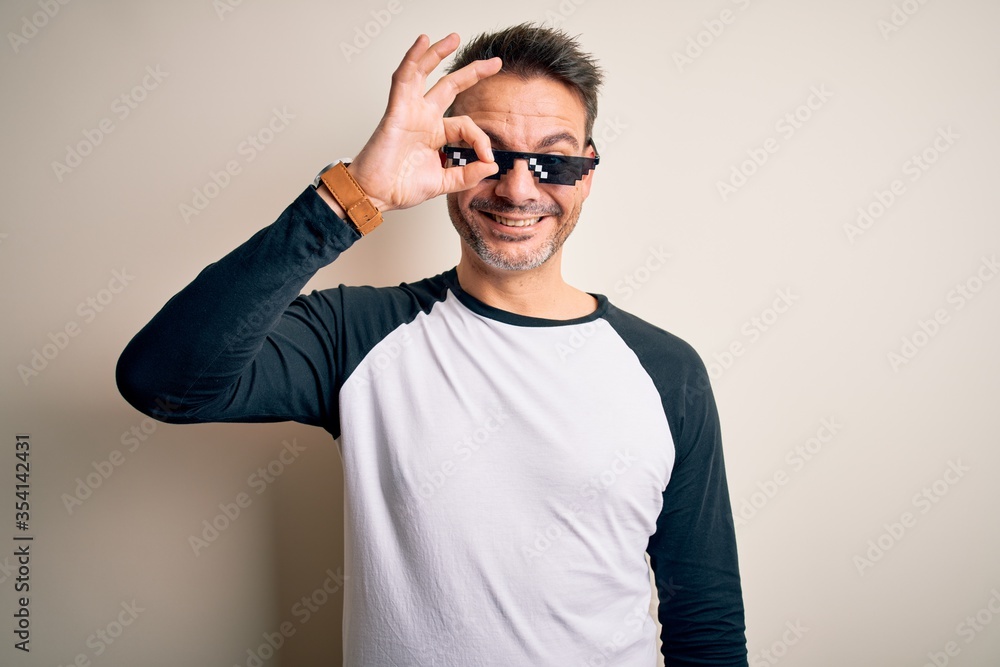 Young handsome man wearing funny thug life sunglasses meme over white  background doing ok gesture with hand smiling, eye looking through fingers  with happy face. Stock Photo | Adobe Stock