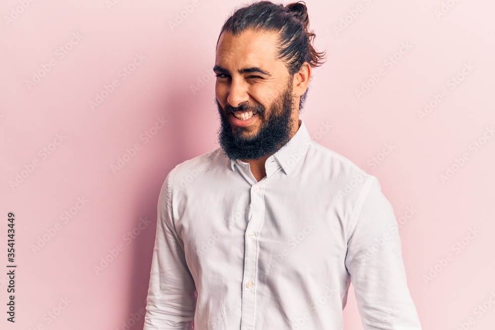 Fototapeta premium Young arab man wearing casual clothes winking looking at the camera with sexy expression, cheerful and happy face.