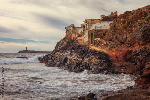 Rustic house on the south cape of Fuerteventura island, in Jandia, the background Jandia lighthouse, Canary Islands, photo