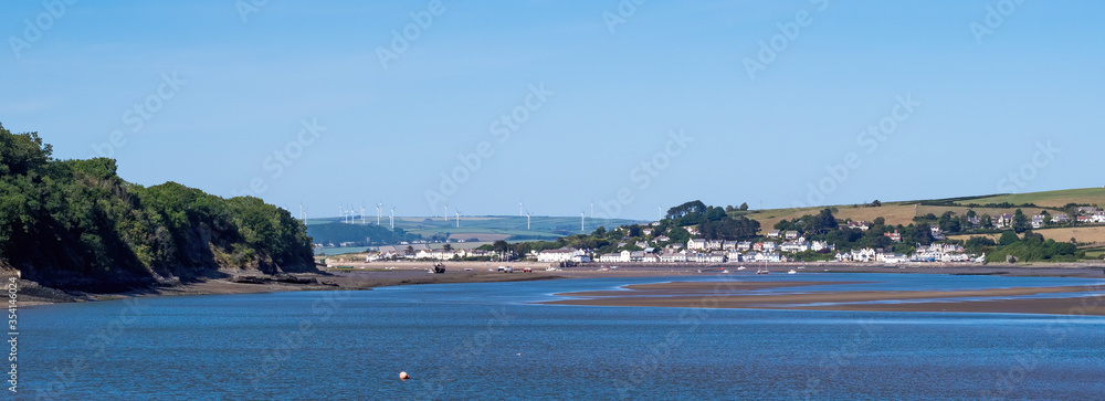 Fototapeta premium Landscape view of the scenic tourist town of Instow in north Devon. Viewed from further down the Torridge estuary, at high tide.