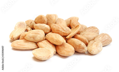 Pile of blanched almonds isolated on white background. Delicious diet food photo