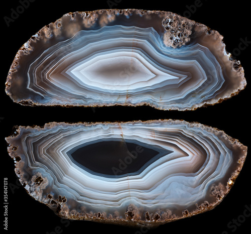 Two halves of white-brown agate geode on black