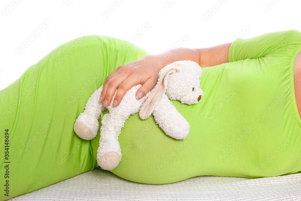 Happy pregnant girl lies on white background Happy pregnant girl lies on white background