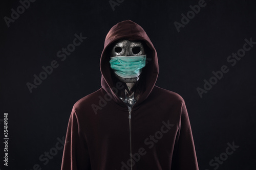 Fototapeta Naklejka Na Ścianę i Meble -  monster in a medical mask in a hood