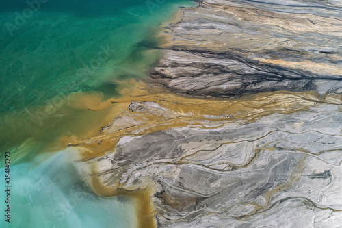 Industrial coal mine, abstract sendimentation tank of power plant , turquoise water like river delta photo