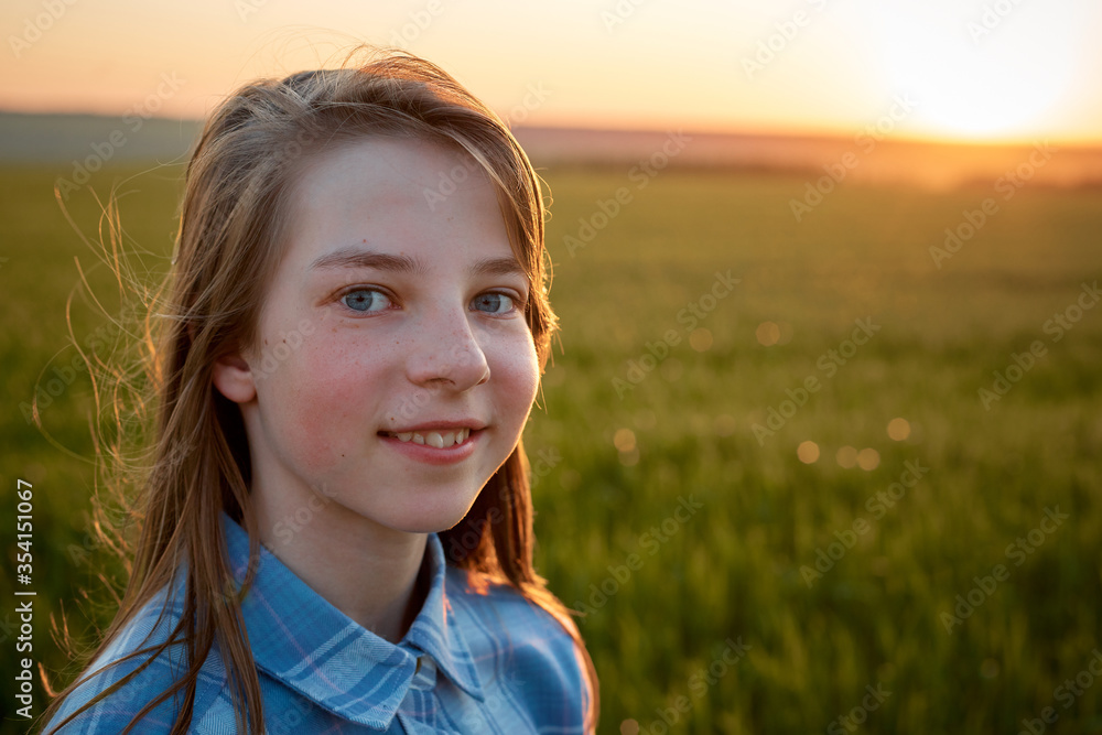 portrait of a teenage girl in a field at sunset portrait of a teenage girl in a field at sunset
