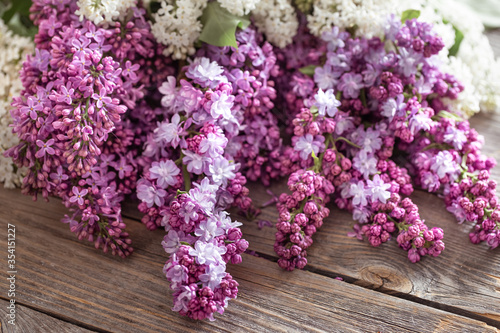 Background of lilac blooming on a wooden background.