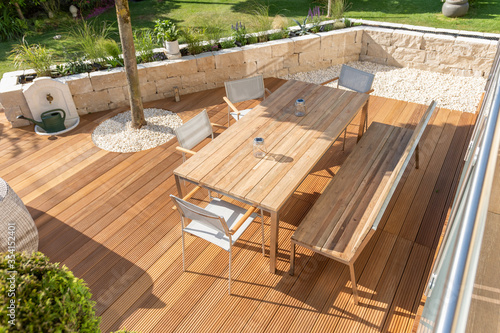 Stampa su tela Teak furniture on a modern wooden terrace in summer