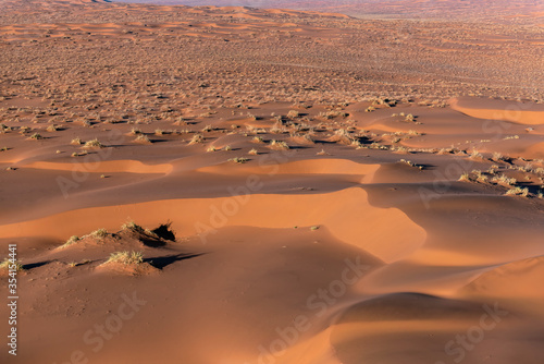 Aerial view of the sand dunes  located in the Namib Desert  in the Namib-Naukluft National Park  Namibia at sunrise.