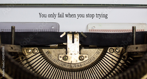 Text 'you only fail when you stop trying' typed on retro typewriter. Business concept. Beautiful background.