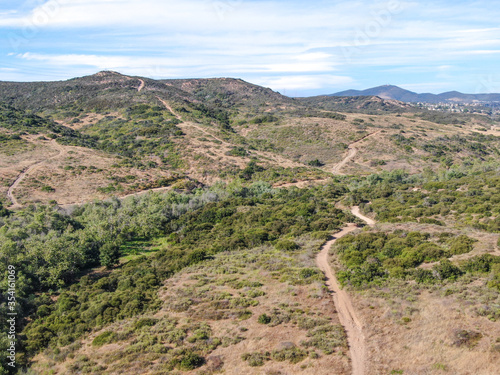 Aerial view of Los Penasquitos Canyon Preserve during dry season. Urban park with mountain and trails in San Diego, California. USA