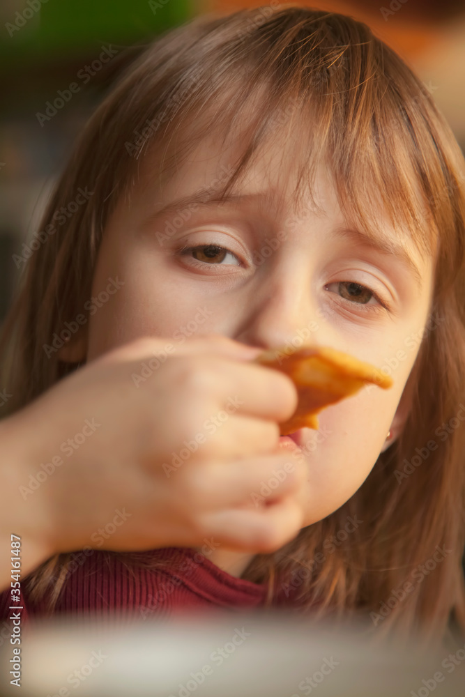 Portrait of little cute child girl eating pancake Portrait of little cute child girl eating pancake