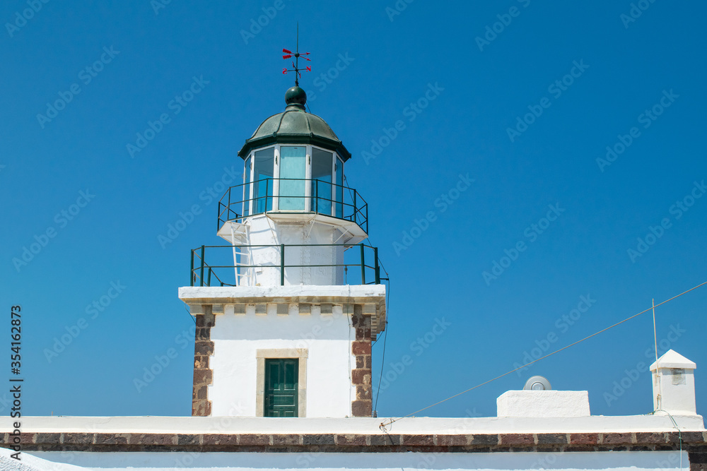 The top of the historic Greek Lighthouse in Akrotiri with a green door at the bottom