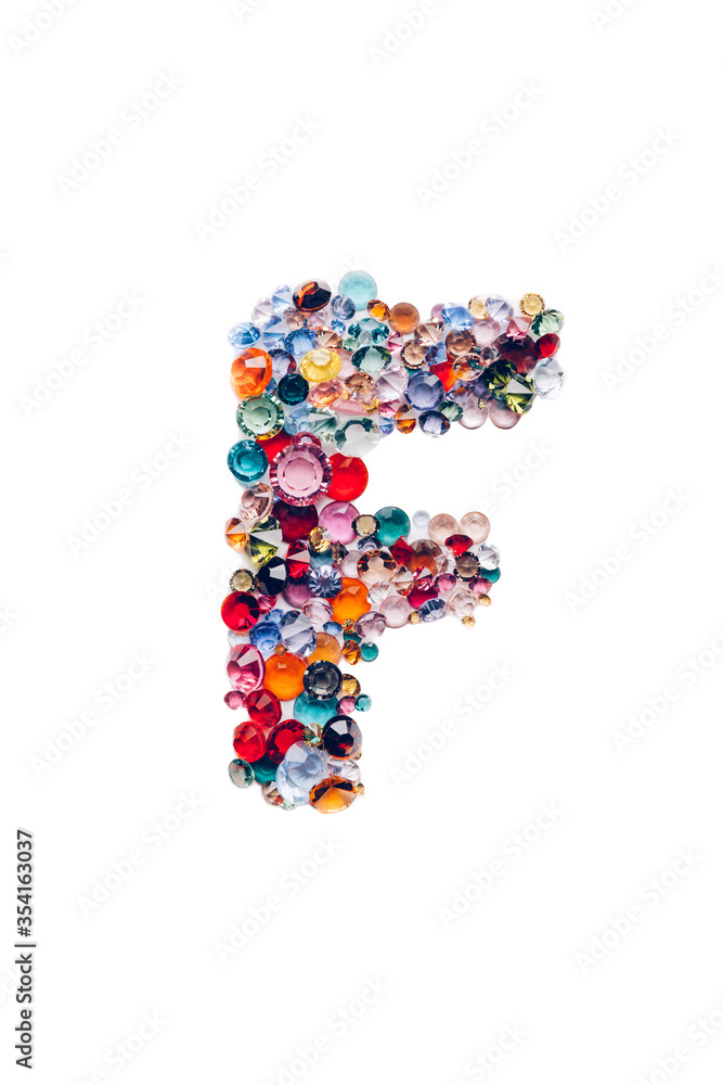 Letter F made from beautiful glass bright gems or crystals on isolated white background