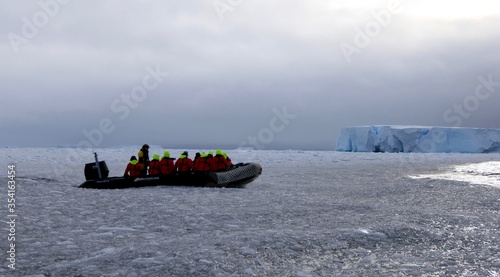 Rubber boat in ice floes at edge of pack ice in antarctic ocean, Antarctica