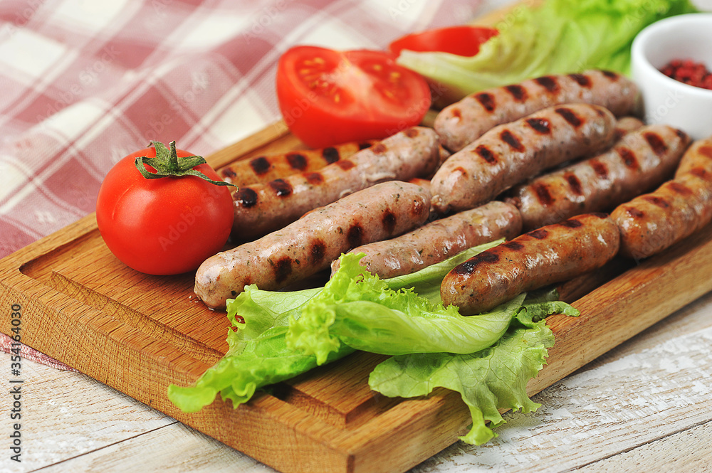 grilled smoked sausages, lettuce leaves, tomatoes grilled smoked sausages, lettuce leaves, tomatoes