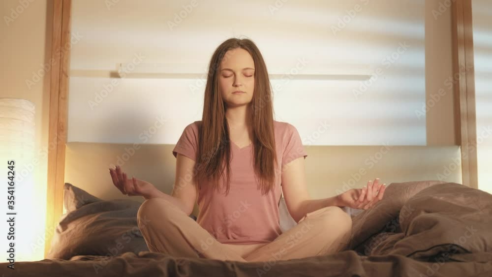 Morning yoga. Peace balance zen. Woman sitting in lotus pose practicing soul healing in bedroom. Morning yoga. Peace balance zen. Woman sitting in lotus pose practicing soul healing in bedroom.
