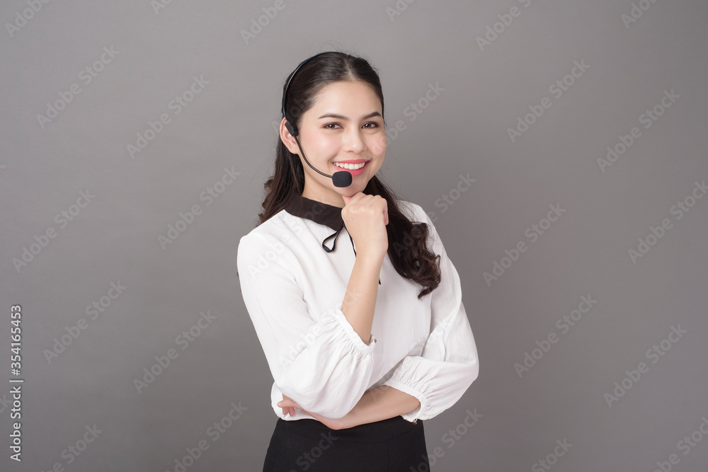 Portrait of beautiful operator woman on gray background Portrait of beautiful operator woman on gray background