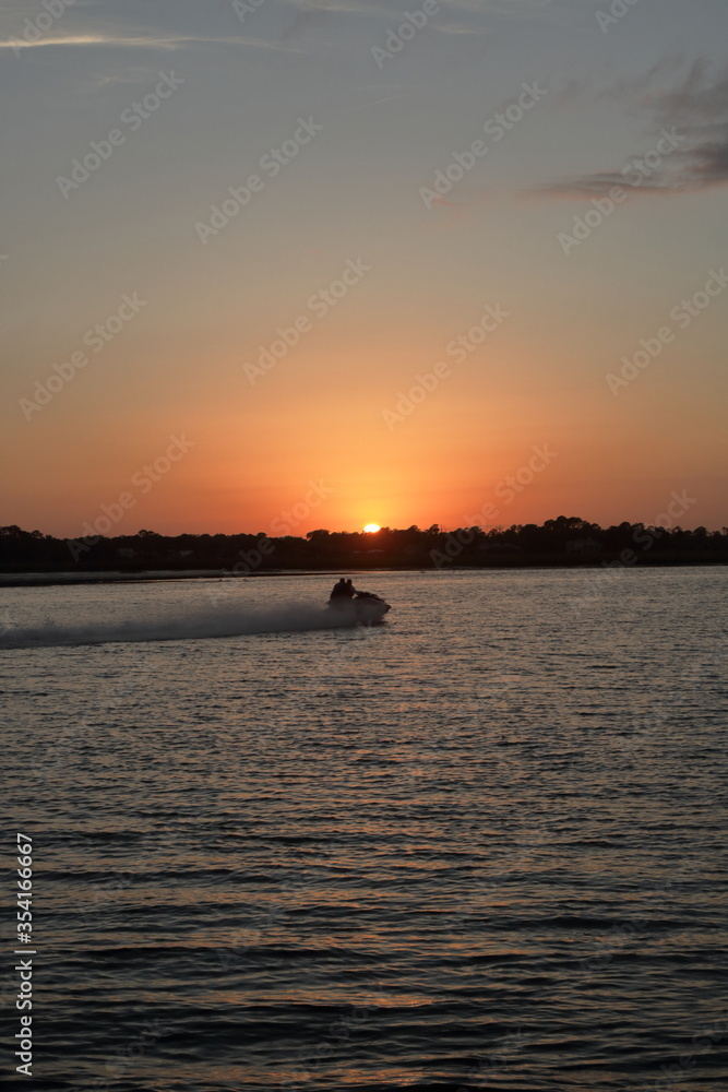 Sunset with jet-ski on intercoastal waterway, Jacksonville, Florida