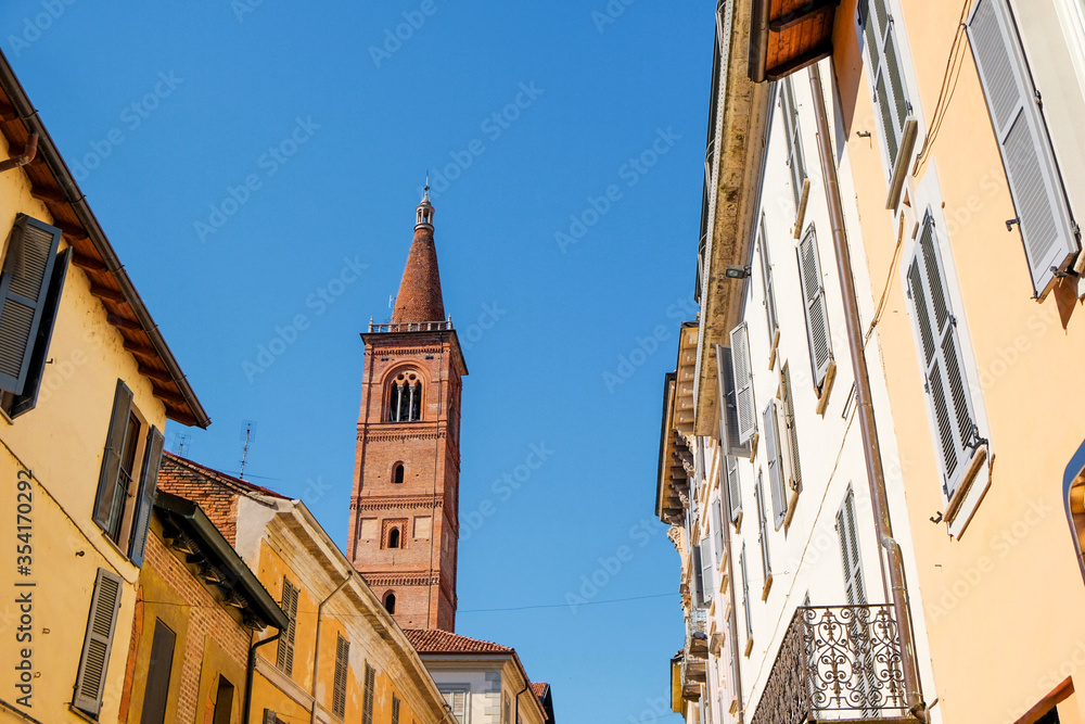 Obraz premium Pavia Lombardy Italy narrow colorful street. Santa Maria del Carmine bell tower