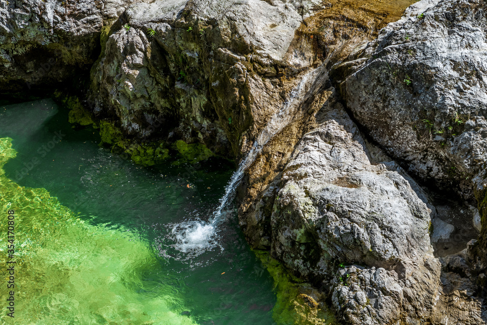 Clear And Fresh Water Flows From Mountain Spring Into River Clear And Fresh Water Flows From Mountain Spring Into River