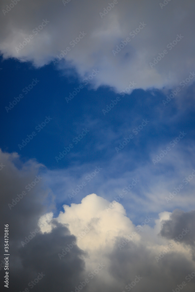 sky blue background with white fluffy clouds