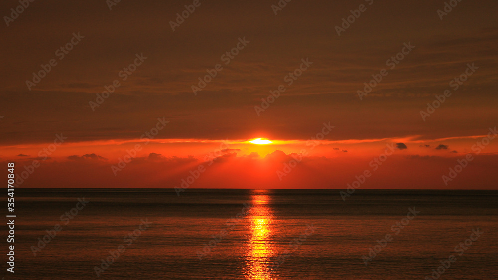 rich red sea sunset with light reflection in the water rich red sea sunset with light reflection in the water