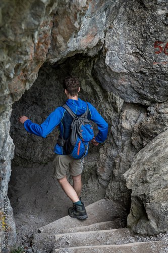 Fototapeta Naklejka Na Ścianę i Meble -  Man On Hiking Trail Enters A Cave In Ötschergräben In Austria