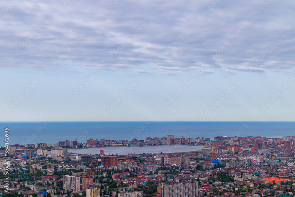 Panorama of the seaside city with a lake in the middle. Cloudy sky background.