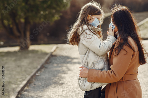 Family walks outside. Coronavirus theme. Mother with daughter.