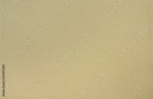 The beige Aida cotton fabric of uniform weave for cross stitch.