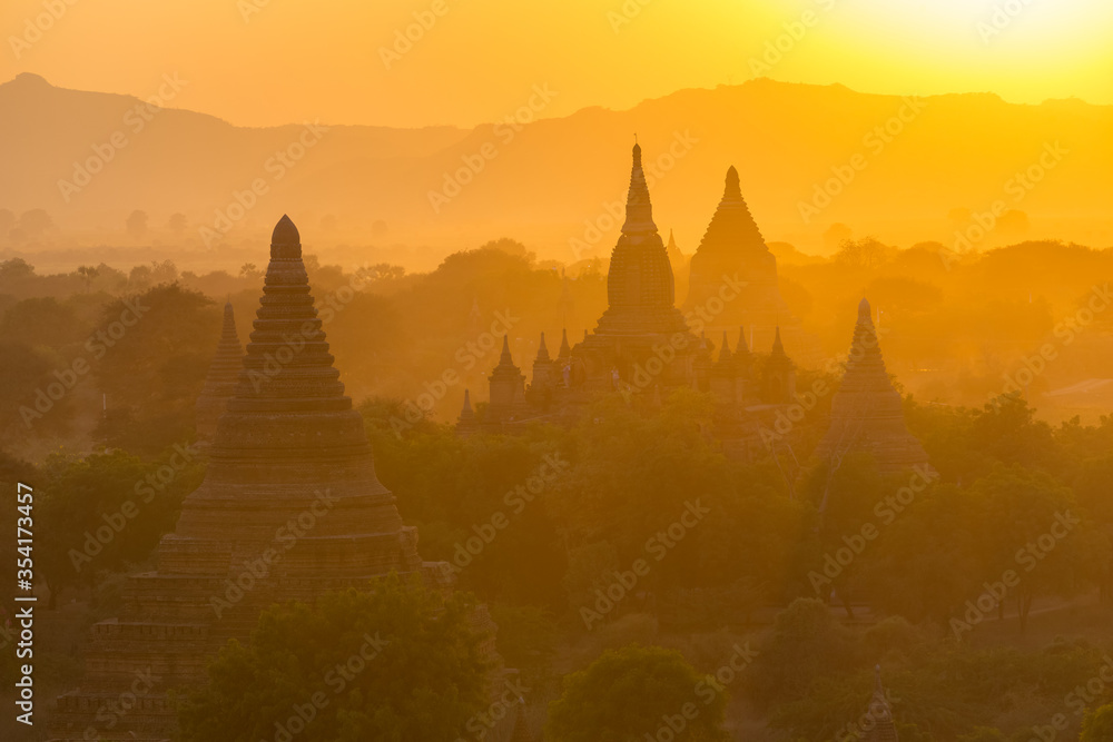 Sunset view on silhouetted pagodas from Shwesandaw paya in Bagan, Myanmar. Bagan is an ancient city with thousands of Buddhist temples and stupas
