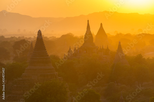 Sunset view on silhouetted pagodas from Shwesandaw paya in Bagan, Myanmar. Bagan is an ancient city with thousands of Buddhist temples and stupas photo