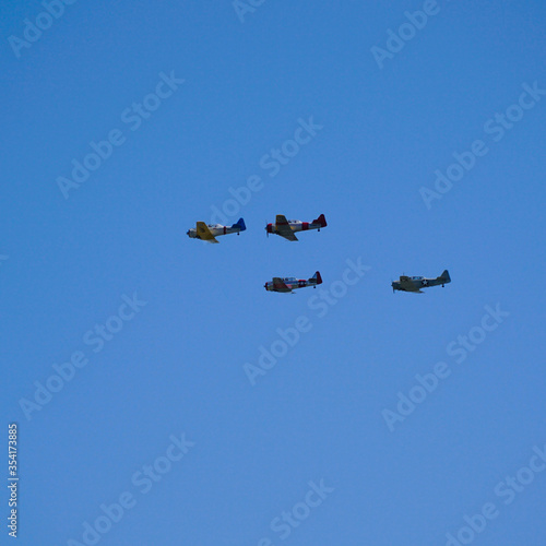 Old war time planes flying in formation.