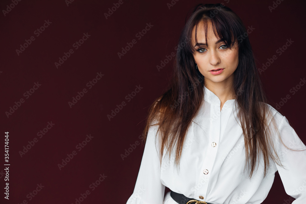 Fashion portrait of girl in a stylish white dress with a black b