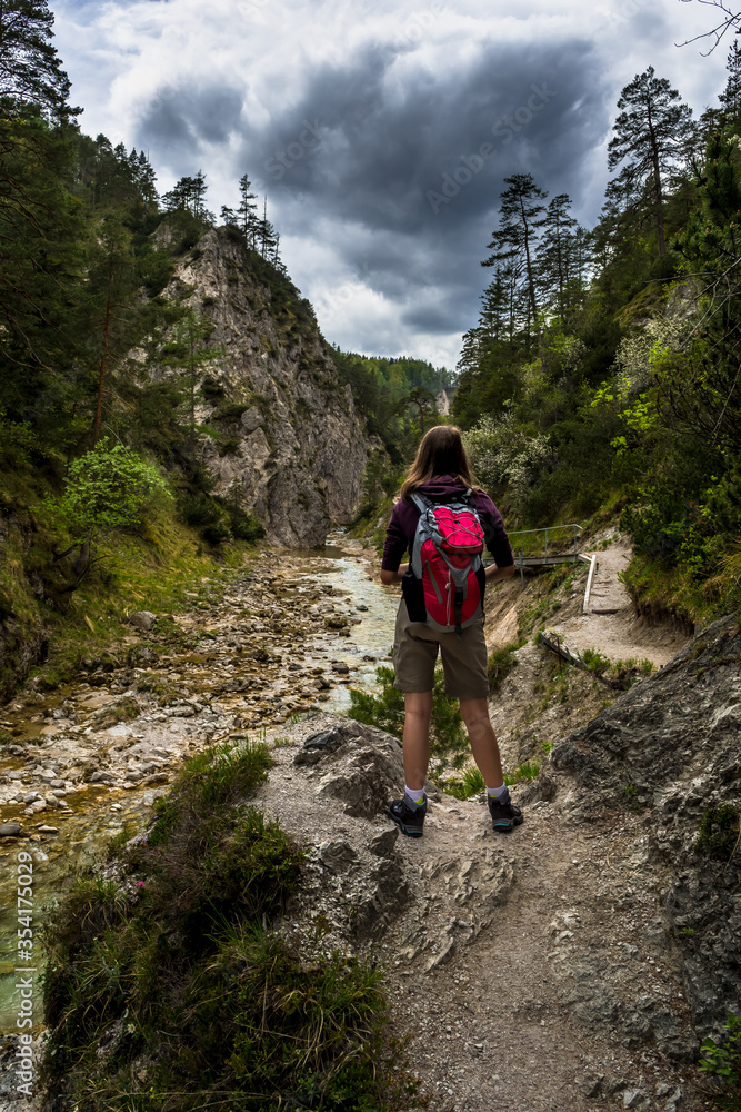 Young Girl Hiking Beneath Clear And Wild Mountain River In Green Canyon In Ötschergräben In Austria