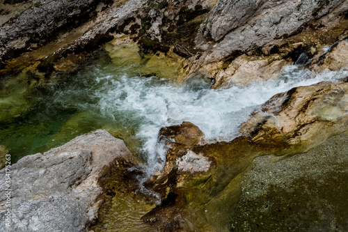 Clear Mountain River Flows Over Dam Between Rocks