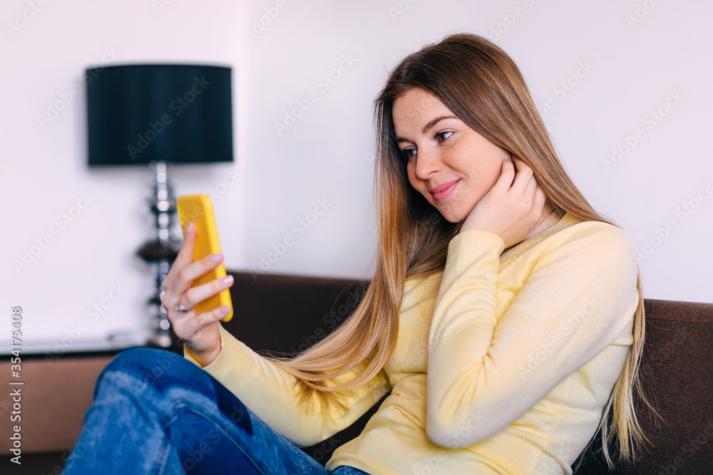 Beautiful young cheerful woman using her smart phone and making Beautiful young cheerful woman using her smart phone and making